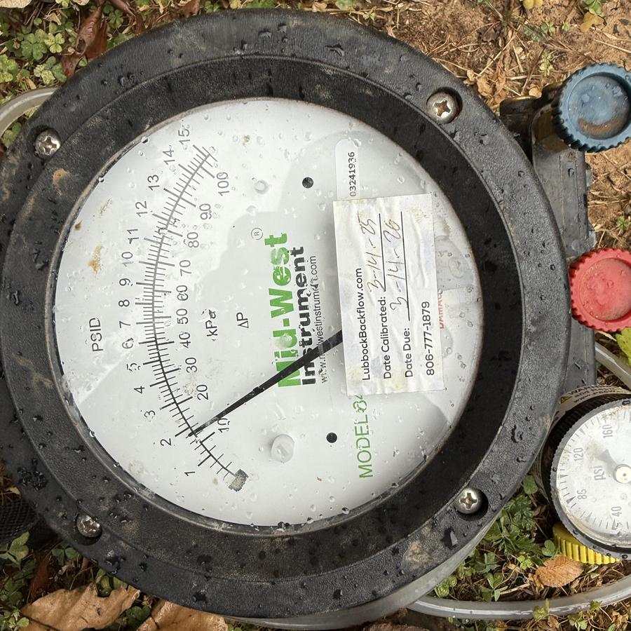 Backflow test kit gauge reading pressure in the field