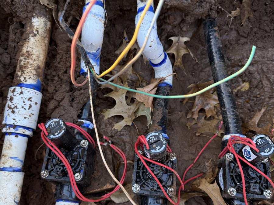 Valve box opened up with valves and wiring exposed for repair